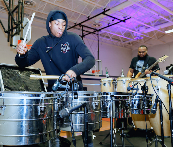 two men playing steel drums