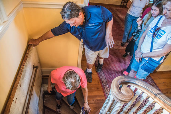 a group of people walking down stairs, learning about the architecture of the building
