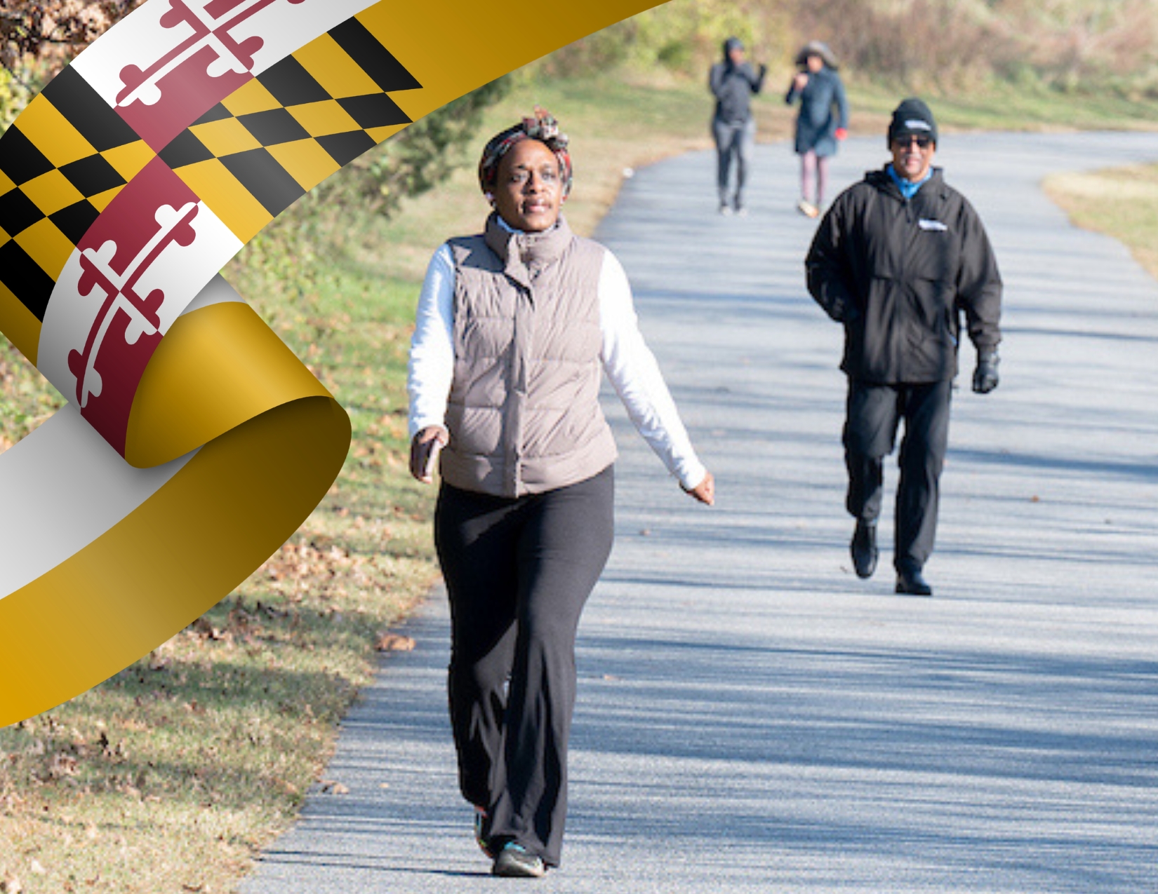 Participants walk on a paved trail during a Walk Maryland Day community fitness event.